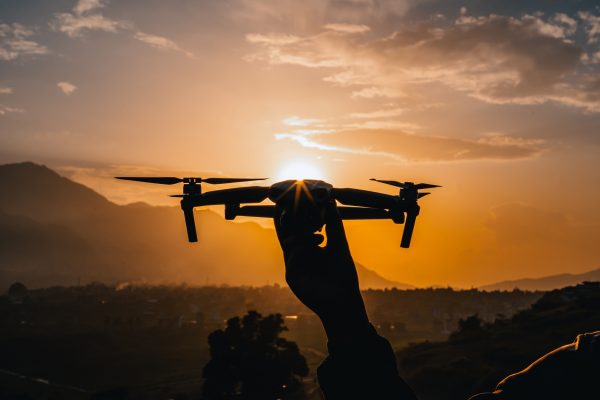 People using wireless technology drone to capture aerial view